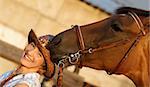 Brown horse try to eat womans hat