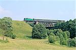 Passenger train passing through the big steel bridge