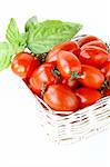 fresh cherry tomatoes and basil over white