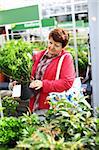 Senior woman buying plants for the garden