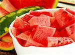 fresh appetizing ripe red watermelon pieces in white bowl