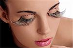 close shot of pretty and sensual brunette  and creative make up with long eyelashes