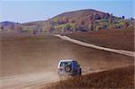 Off-road vehicle running in Bashang grassland, Hebei province, China.