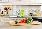 Modern kitchen interior with fresh vegetables on natural stone countertop