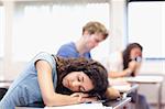 Student sleeping on her desk in a classroom
