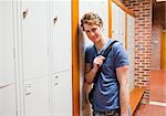 Student leaning on a locker in a corridor