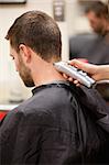 Portrait of man having a haircut with a hair clippers