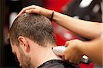 Close up of a male student having a haircut with hair clippers