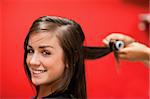 Smiling woman having her hair rolled with a curler