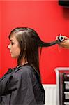 Portrait of hands rolling hair with a curler