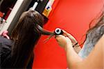 Hairdresser rolling hair with a curler