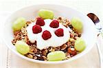 Healthy breakfast with muesli, fresh yoghurt, grapes and raspberries