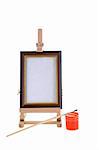 Easel, paint and small brush on white background