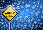 winter ahead traffic sign on snowing background