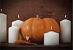 Pumpkin with candels on the wooden background