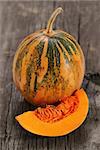 Small pumpkin on the rustic wooden background