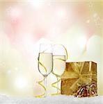 Champagne in two glasses with present and Christmas decoration on  the Christmas background