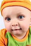 Baby boy wearing an orange pumpkin costume