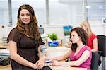 Woman sitting happily on a desk