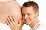 Man Listening To Pregnant Woman's Stomach