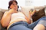 Overweight Woman Relaxing On Sofa