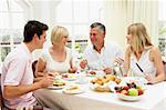 Family Group Enjoying Hotel Breakfast