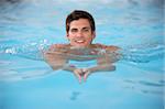 Young Man Swimming In Pool