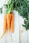 Fresh organic carrot with green leaves on  table