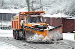 Orange snow plow in action