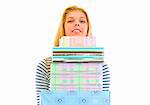 Pretty teen girl holding stack of present boxes isolated on white