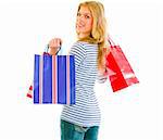 Smiling teen girl with shopping bags isolated on white