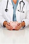 Female Doctor with Caring Hands on a Piggy Bank.