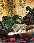 Natural spa setting with rose water and towel.