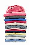 Stack of warm sweaters isolated on white background