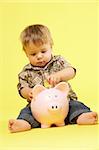 Toddler In Studio With Piggy Bank