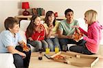 Group Of Children Eating Pizza At Home