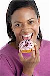Woman Taking Bite Of Doughnut