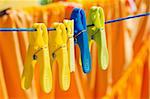 Washed clothes drying outside with cloth pegs