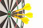 Three darts hitting the bullseye on a dartboard