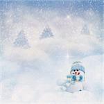Snowman toy on the bokeh winter background