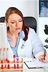 Busy female medical doctor working at office