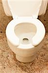 White clean toilet bowl with opened cover and seat