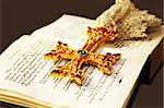 Golden cross with gemstones on Holy Bible.