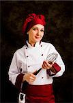 photo of young successfull female chef with whip in her hands