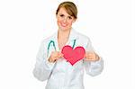Smiling medical doctor woman holding paper heart isolated on white