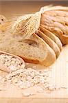 Close-up of fresh bread slices, barley and oats. Shallow dof