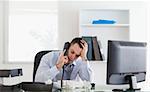 Stressed and frustrated businessman on the phone