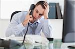 Close up of depressed and frustrated businessman on the phone