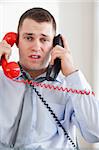 Close up of stressed businessman troubled by the telephone