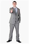 Smiling businessman giving thumb up on white background